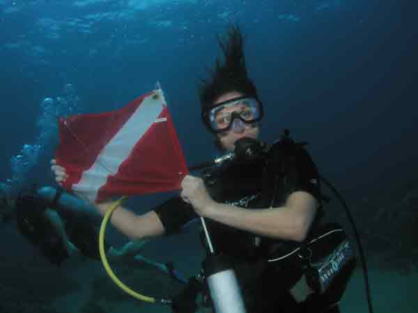 Open Water Scuba Referral Certification Diver In Maui Holding Dive Flag